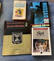 Five Jewish books arranged on a surface, showing titles clearly for identification.