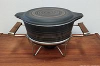 Closed Pyrex Terra Pattern warming dish on warming holder.