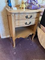 Light wood Drexel end table with two drawers closed, showing scalloped and carved details.