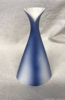 Front angled view showing the curved flared lip and gradient blue to white glaze.