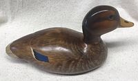 Side view of the wooden mallard hen carving showing the smooth finish and detailed paintwork.