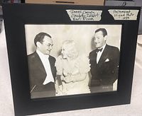 Frontal view of black and white vintage studio photo framed in black, showing the three actors identified with handwritten labels.