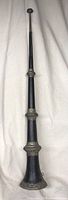 Full view of the large black collapsible Tibetan Dungchen trumpet showing its full length with metal decorative accents.