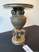 Front view of entire bronze stand