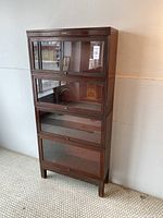 Front view of full four-tier steel barrister bookcase with glass doors closed
