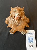 Top front view of cold painted metal lion inkwell with visible wear on paint and open mouth showing teeth; Maxsold tag next to item