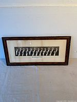 Full view of the framed panoramic black and white photograph of a fraternity group, showing the complete frame and photo.