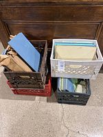 Four crates containing stacked vintage Vitrolite glass tile panels in various colors, mostly rectangular and mostly 12x16 inches size.