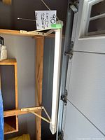 LED 2 tube work light mounted on table showing pull cord and mounting brackets