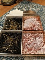 Set of four gift boxes: two white matte with black/gold paper stuffing, two rose gold metallic with white/rose gold paper stuffing