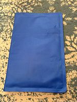 Blue foldable pet cooling gel mat shown folded and unfolded.