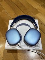Top view of blue Bluetooth headphones showing metallic finish on ear cups and padded head strap.
