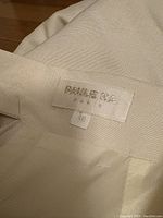 Close-up photo of the Paule Ka Paris label and size 40 tag inside the cream skirt.