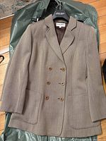 Full front view of the vintage Giorgio Armani double-breasted blazer showing button detail and patch pockets on taupe textured fabric.