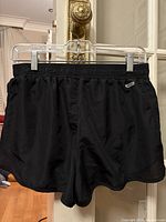 Front view of black dri-fit athletic shorts with elastic waistband and small logo on front left.