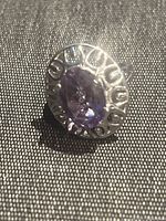 Top view showing oval purple amethyst gemstone set in detailed sterling silver bezel.