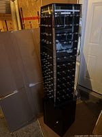 Full tall display case with hooks on all sides and locked cabinet base