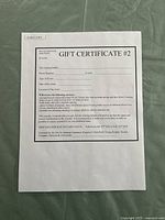 Full front of gift certificate showing title, blank bidder and event fields