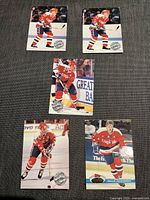 Front sides of five Washington Capitals hockey cards showing players in action and posing