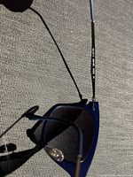 Close-up image showing the frame side arm with printed model details: 895/8G 50 22 3N RB 42 light ray made in Italy.