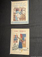Two vintage cookbooks placed on a dark background, showing cover art and titles 'Early American Recipes' and 'A World of Good Eating'.