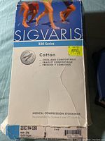 Photo of the front of the Sigvaris 230 Series Medical Compression Stockings box showing branding, compression level, cotton material, size M4, and signatures on the box.