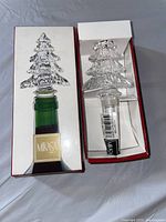 Boxed Mikasa bottle stopper shaped as a clear glass Christmas tree, displayed inside its original packaging showing label and product image
