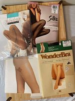 Four packages of pantyhose from Calvin Klein, Filodoro, Silks Essentials, and WonderBra showing different colors and styles.