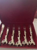 Six PC Cheshire reindeer butter spreaders displayed in red velvet-lined box.