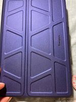 Front side of the blue Targus iPad case showing geometric textured pattern and Targus logo