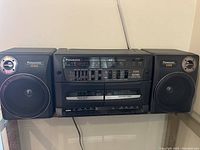 Front view of Panasonic boombox with dual cassette decks and two detachable speakers
