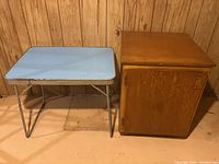Photo of vintage child's metal table and wooden cupboard side by side.