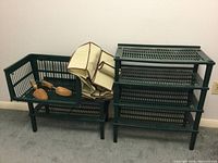 Green plastic stacking shoe shelves grouped together with cloth shoe organizer folded on top and wooden shoe stretchers inside basket.