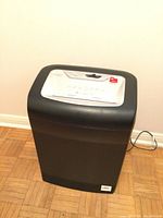 Full view of the black and gray Staples paper shredder showing overall condition and design.
