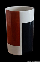 Front view showing vase with rust red and black rectangular blocks on white porcelain.