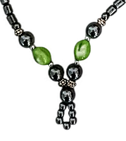 Close-up of the necklace central pendant with mixed green nephrite and hematite-like beads.