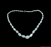 Full view of the moonstone necklace showing the entire strand, the clasp, and graduated beads from smaller to larger in the center.