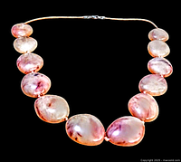 Full view of vintage semi-precious pink gemstone necklace on gold-toned wire with clasp.
