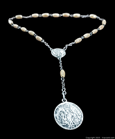 Full view of the vintage sterling silver rosary showing wooden beads linked by sterling silver chain and two silver medallions with religious figures.