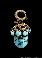 Front view of turquoise art glass pendant with brass cap and bail