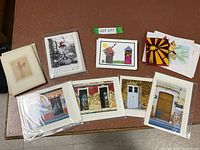 Assorted cards laid out on table, including sets with rustic doors, lighthouse, angel artwork, and colorful designs