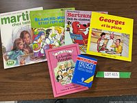 Photo showing the entire set of 5 French children's books and the Collins Gem French Dictionary with lot number.
