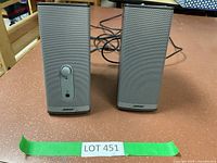 Front view of the two Bose Companion 2 Series II speakers with visible volume control and headphone jack on the left speaker.