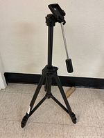 Full view of black Velbon Stratos 4600 camera tripod showing legs and pan handle.
