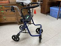Side angle of blue Evolution walker showing frame, wheels, black molded plastic seat, hand grips and dual hand brake levers.