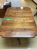 Top view of the full wooden gate leg table showing extended surface and wood grain.