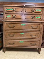 Full front view of the two-tier seven-drawer dresser with green tape labels