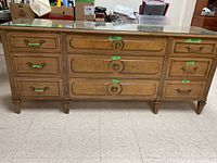Full front view of Gibbard dresser showing nine drawers and glass top
