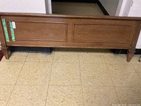 Front view of the footboard showing wood grain and panel design