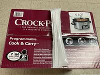 Front of the box showing Crock-Pot programmable Cook & Carry slow cooker with image of the appliance and capacity details.